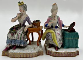 Pair of 19th century Meissen porcelain figures of ladies sat at tables, with bocage work, 14cm high