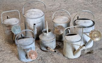 Collection of seven vintage galvanised watering cans (7)