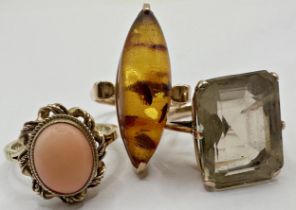 9ct coral set ring, size L/M, 9ct smoky quartz dress ring, size M/N and a 14ct amber ring, size M,