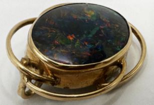 Mid 20th century yellow metal black opal brooch in scrolled mount, the stone 20 x 15mm, 3cm high