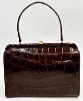 A stunning 1940s brown crocodile skin handbag. Hardware in gilt metal with clasp opening to the