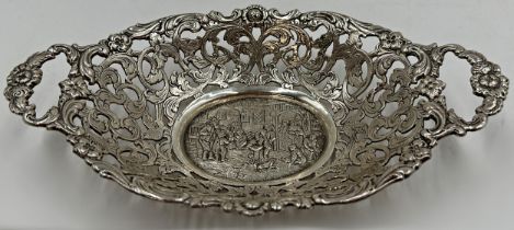 Continental white metal (untested) twin handled dish, with central cast exterior tavern scene,