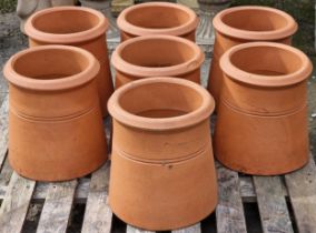 Seven terracotta chimney pots, 31cm high