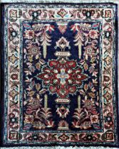 Persian rug, central red medallion and scrolled foliage on navy blue ground, L88 x W72cm