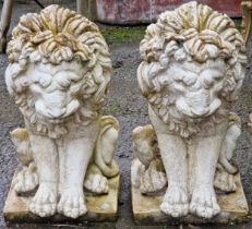 Pair of reconstituted stone garden ornaments in the form of seated lions, 42cm high