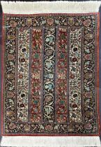 Fine quality probably Indian silk small rug or prayer mat decorated with vertical panels of scrolled