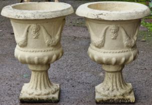 Pair of reconstituted buff coloured stone garden urns with cherub mask and swag detail, 54cm high