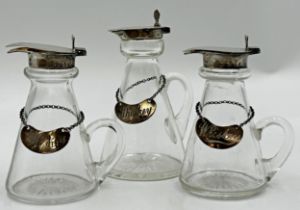 Pair of silver and glass whiskey tots, with star cut bases, maker Barker Brothers Silver Ltd,