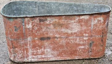 Vintage galvanised trough of triangular form with rivetted seams, 63cm high x 131cm wide