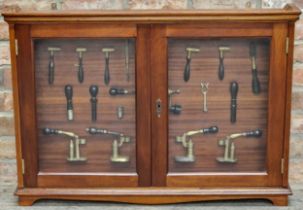 Mahogany display cabinet containing a collection of antique cartridge reloading tools, 69cm high x