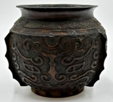 A Japanese bronze Koro or vase, decorated in relief with scrolled panels, 10cm high