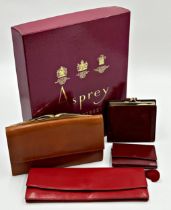 Asprey box containing four leather purses by Asprey comprising longline purse in soft red leather.