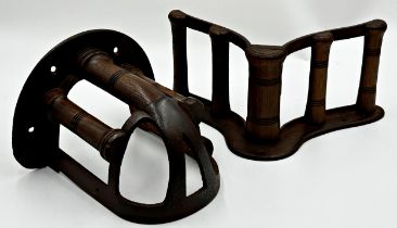 Two antique cast iron and turned wooden saddle racks by Musgrave, the largest 33cm long (2)