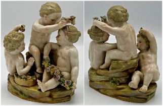 19th century Meissen porcelain character group with three cherubs and bocage flower work, hand