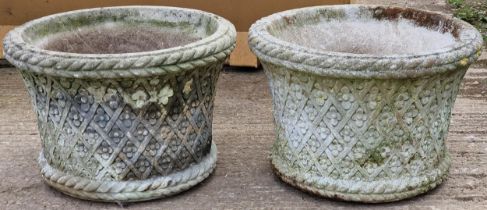 Pair of good quality weathered Haddonstone garden planters, with reticulated flowerhead and basket