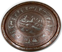 Large copper and silver applied Egyptian charger with various figures and scenes, 65cm diameter.
