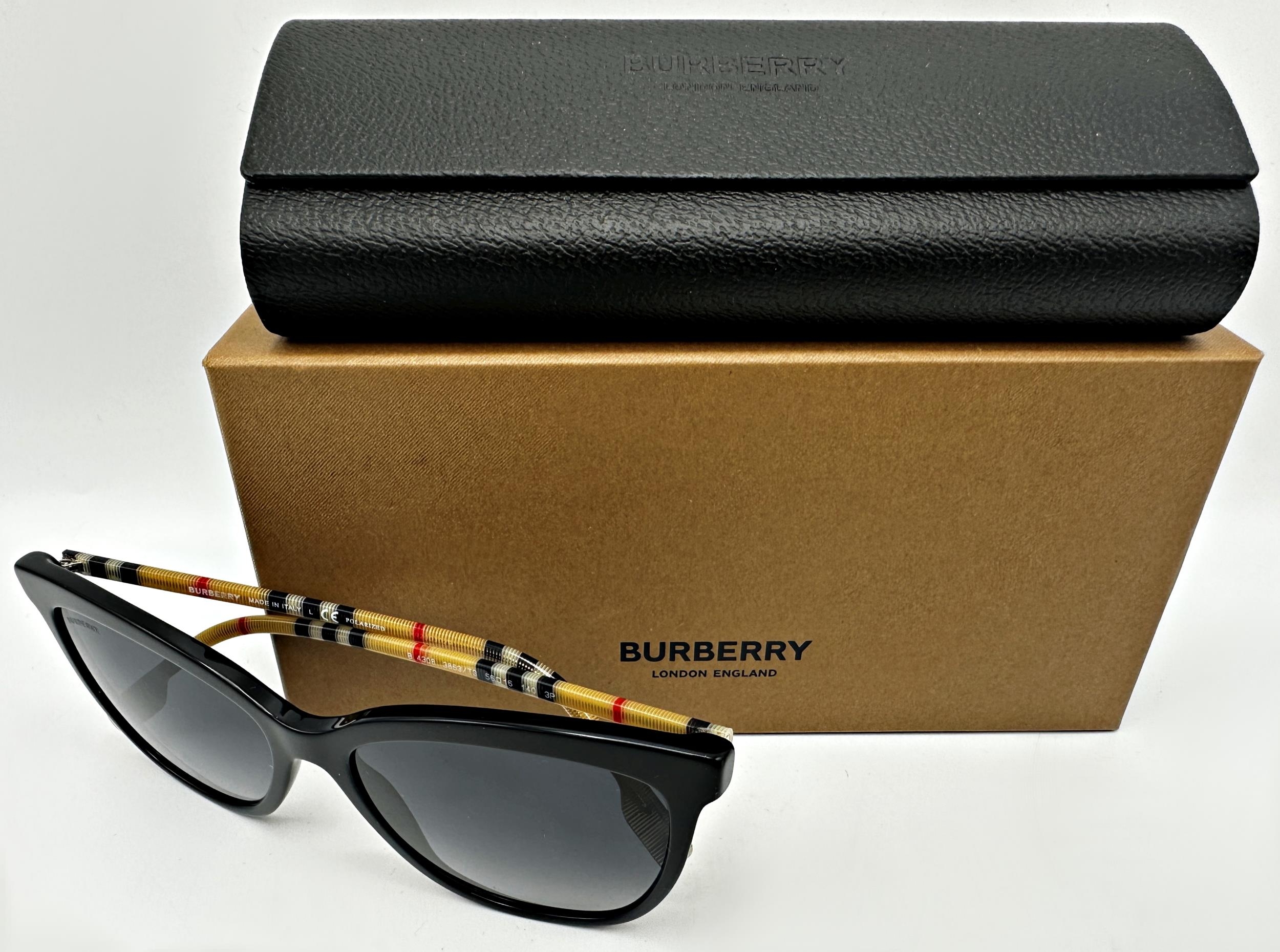 A pair of Burberry Clare sunglasses with black frames and Burberry check temples. In unused - Image 2 of 5