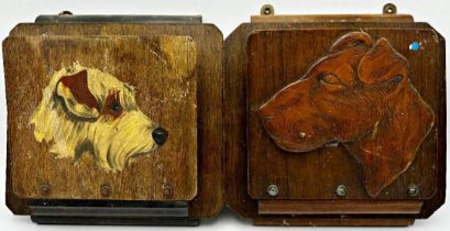 Two similar wall hanging paper racks decorated with dog heads, 24 x 24cm (2)