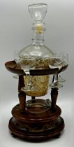 Continental walnut musical decanter stand, with glass decanter and five glasses, 36cm high in total