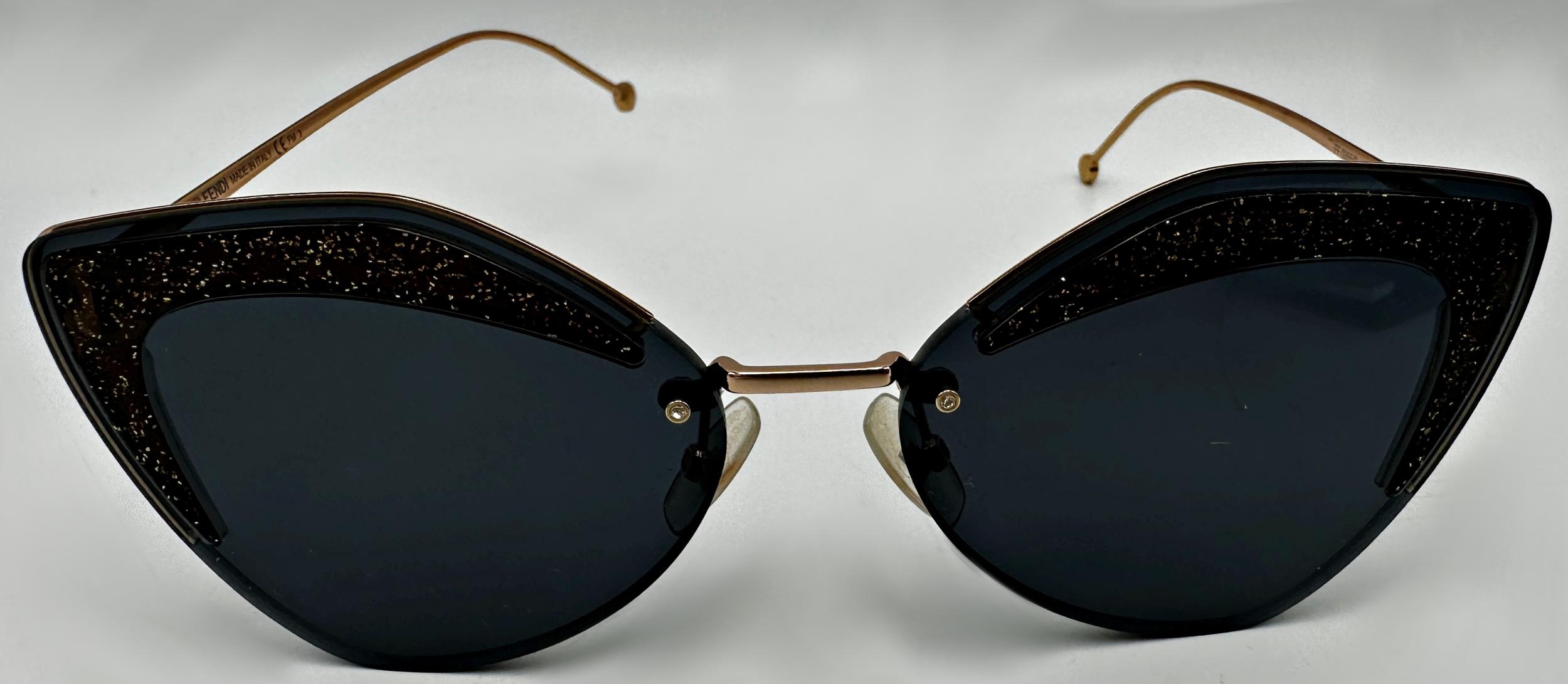 Fendi Eyewear Glittered Cat Eye Sunglasses in black and gold with branded dust cloth and case