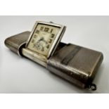 Good early 20th century engine turned silver purse clock by Eszeha, 5.5cm long