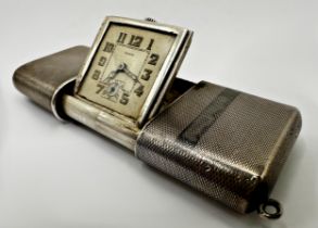 Good early 20th century engine turned silver purse clock by Eszeha, 5.5cm long