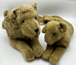 Vintage straw stuffed recumbent lion, tail to head 603cm, with a similar lioness (2)