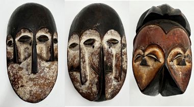 Tribal interest - three Nigerian 'Joroba' carved twin faced masks, the largest 36 x 20cm
