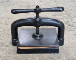 Victorian cast iron book press with lion trade mark to underside, H 32cm x W 40cm x D 25cm