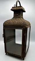 19th century pierced sheet metal storm lantern with three glass panels, 52cm high