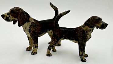 Graduated pair of Austrian cold painted bronze standing foxhounds, the larger of the two