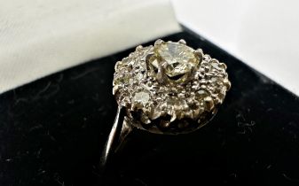 18ct diamond flower head cluster ring, central 0.25 diamond framed by ten smaller illusion set