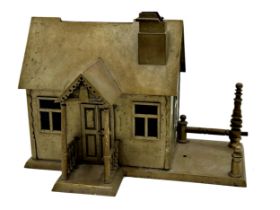 Novelty brass cigarette dispenser in the form of a cottage, the fence post acting as a lever, 23cm H