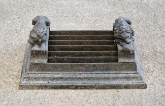 Victorian cast iron boot scraper with stepped base, flanked by recumbent lions, H 21cm x W 46cm x