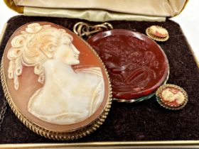 Yellow metal shell cameo suite, brooch and earrings, the brooch 4.5 x 3.5cm with a further