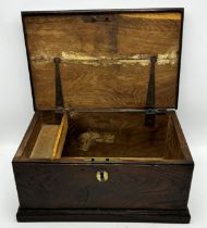 18th century elm candle box, the hinged lid enclosing a fitted interior, 18cm high x 39cm wide