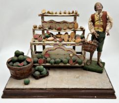 19th century Italian Folk Art Creche fruit seller, standing figure with basket of fruits in a