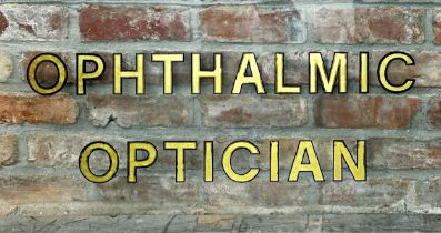 Good vintage glass opticians sign with gilt lettering inscribed "Ophthalmic Optician", 46cm x 92cm