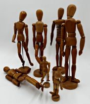 Collection of seven artists articulated mannequin dummies to include five large and two small,