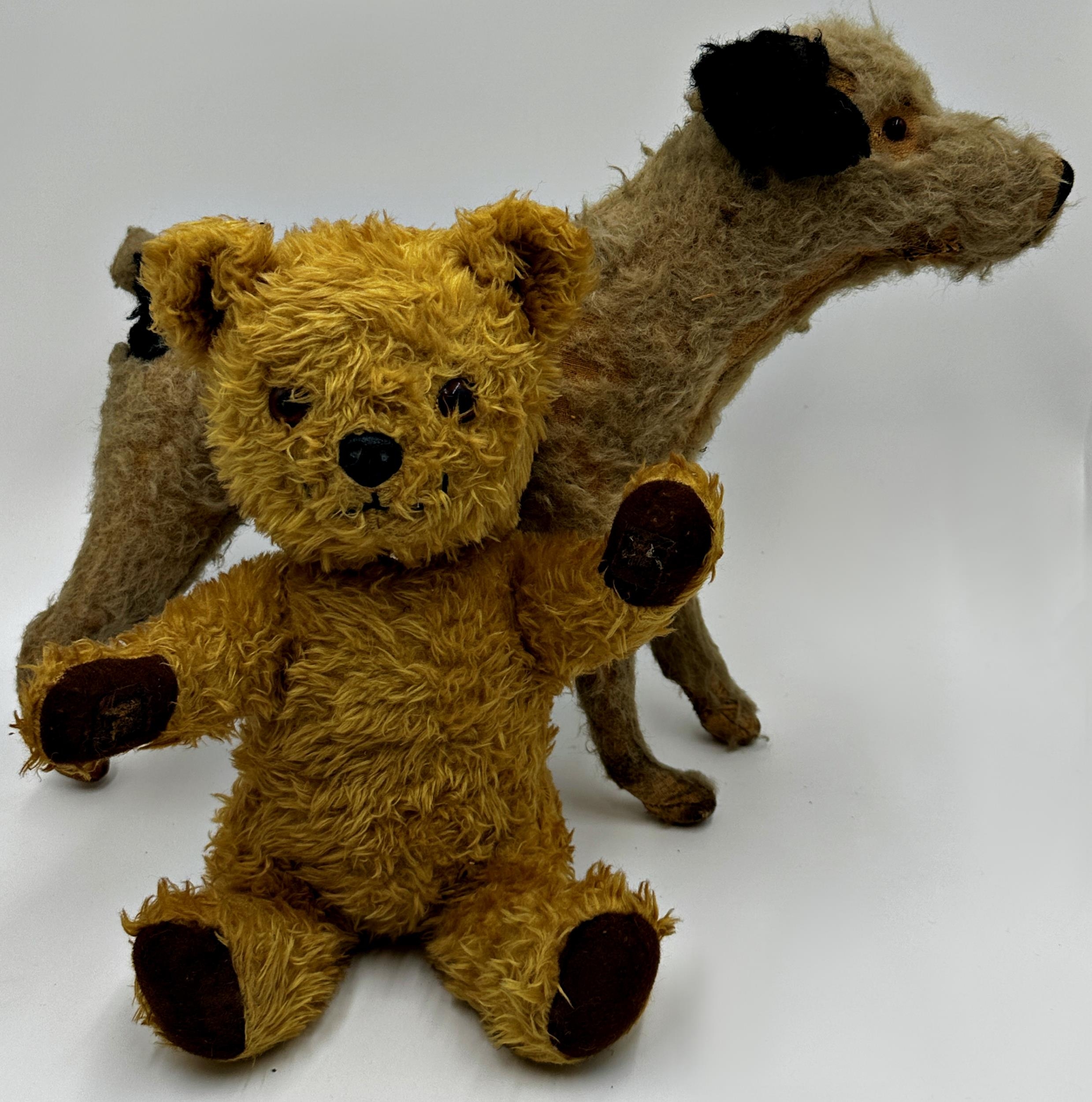 Early straw stuffed standing dog, 33cm high x 42cm long with a further vintage teddy (2)
