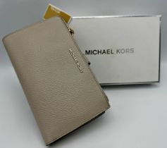 Michael Kors double zip wristlet purse in light sand pebbled leather with gilt hardware. Unused