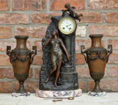 French bronzed spelter figural clock garniture, the clock modelled as a maiden stood at a pillar
