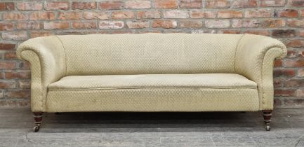 19th century upholstered chesterfield sofa with scrolled arms, raised on turned legs with ceramic