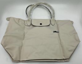 Longchamp Le Pliage classic large foldaway tote in cream canvas with leather trim, press stud