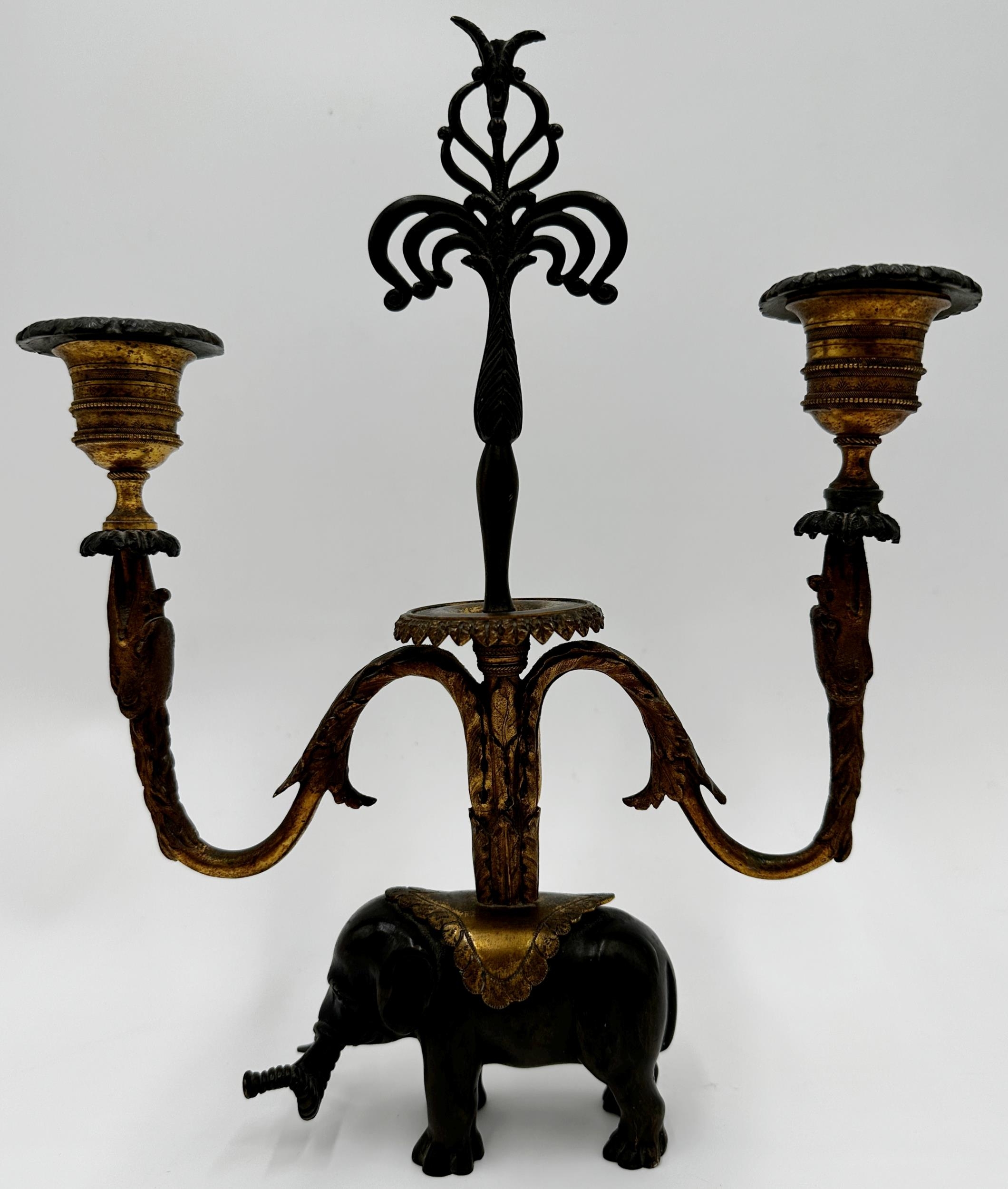 French bronze and ormolu twin branch candelabra, scrolled gilt branches on a cast standing elephant,