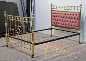 Victorian brass bedstead with iron side rails, cushioned headboard and studded edging raised on