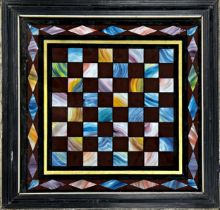 Good Italian antique painted slate games board in the pietra dura style, framed and glazed, 54 x
