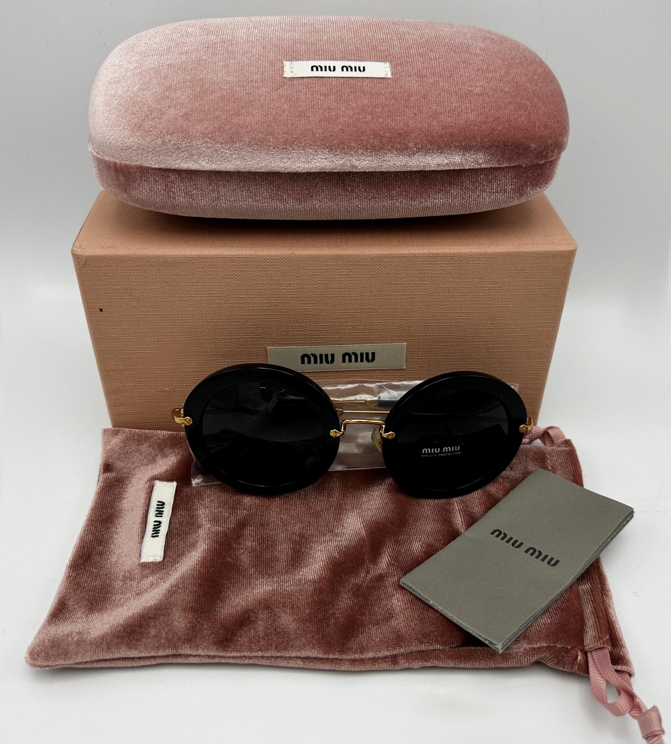A pair of Miu Miu Woman's black round-frame sunglasses. Model number SMU 13N. In unused condition - Image 2 of 4