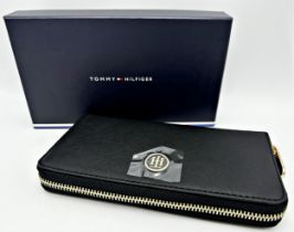 Tommy Hilfiger Honey large zip-around faux leather black wallet with multiple internal compartments.