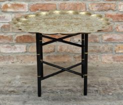 Indian engraved brass tray top table with folding ebonised stand, H 48.5cm x W 71cm